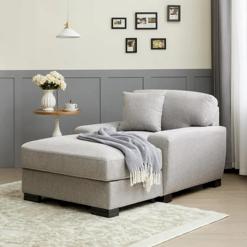 Chaise longue tapizada moderna con brazos acolchados y patas de madera