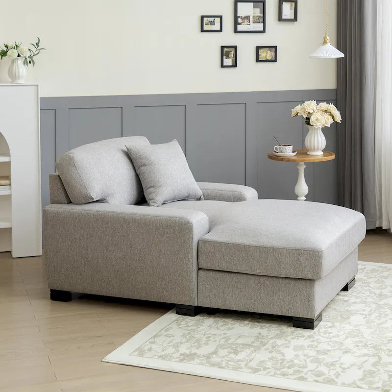 Chaise longue tapizada moderna con brazos acolchados y patas de madera