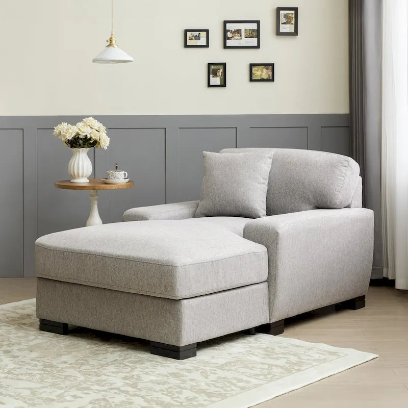 Chaise longue tapizada moderna con brazos acolchados y patas de madera