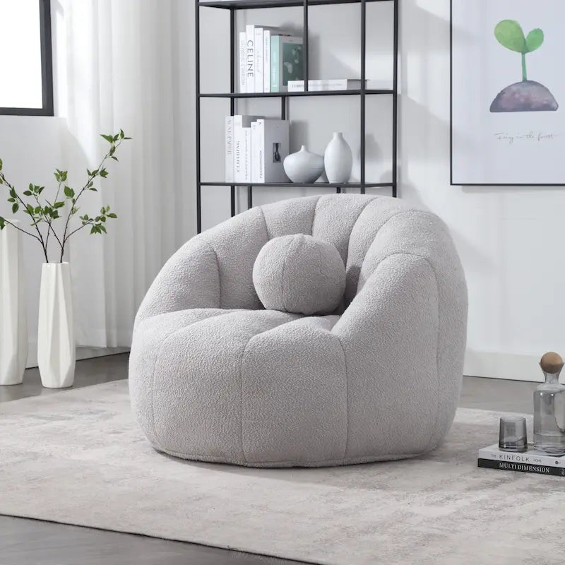 Sillón tipo puf redondo tapizado, de textura suave, para leer