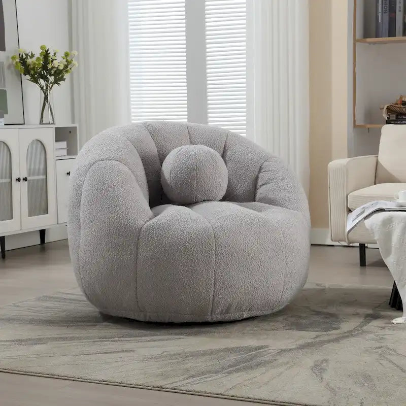 Sillón tipo puf redondo tapizado, de textura suave, para leer