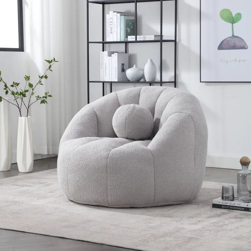 Sillón tipo puf redondo tapizado, de textura suave, para leer